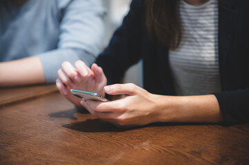 professional business person holding smartphone and using to work with communication technology, smart mobile phone, people smiling and happy at modern office