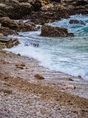 Waves on the beach with bays and rocks in Croatia