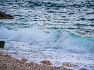 Waves on the beach with bays and rocks in Croatia