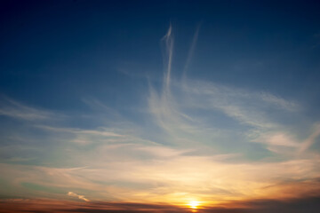 Dramatic sunset sky with clouds.