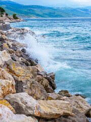 Waves on the beach with bays and rocks in Croatia