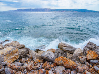 Waves on the beach with bays and rocks in Croatia
