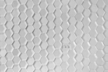 electrical outlet on the wall of white tiles in the form of a honeycomb. Gray Hexagon Background wall Texture. wall background.