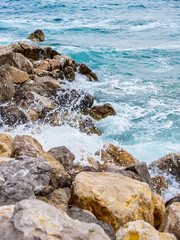 Fototapeta na wymiar Waves on the beach with bays and rocks in Croatia