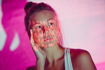 Young adult woman with word Woman on her body.