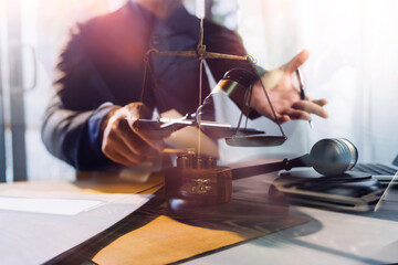 justice and law concept.Male judge in a courtroom on wooden table and Counselor or Male lawyer...