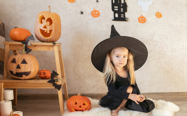 A girl on Halloween dressed in a witch costume