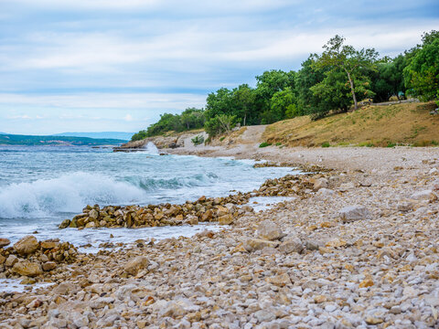 Waves on the beach with bays and rocks in Croatia
