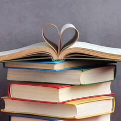 stack of thick hardcover books heart shaped pages