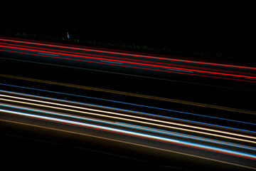 Night road lights. Lights of moving cars at night. long exposure multicolored