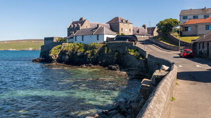 Lerwick seafront from Commercial Street showing traditional stone and slate homes by the sea