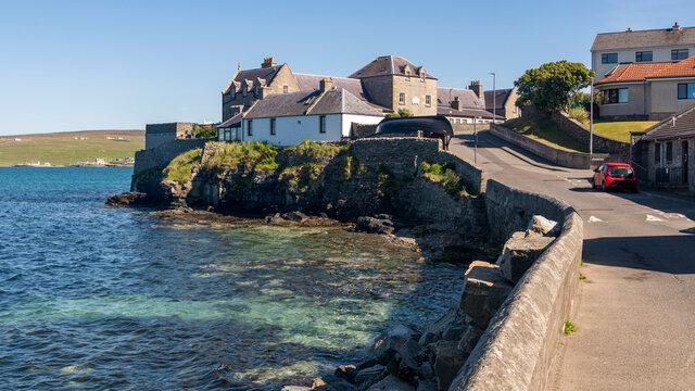 Lerwick seafront from Commercial Street showing traditional stone and slate homes by the sea