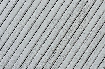 White cracked wood boards diagonal background.