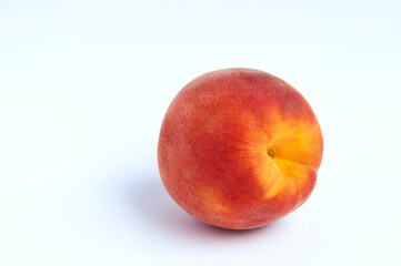 Fototapeta na wymiar Red peach on light background