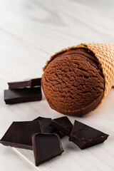 chocolate ice cream in a cone with pieces of chocolate
