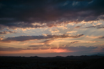 Sunset point in Urgup, Goreme with just before sun goes away in rose valley sunset (kizilvadi) and dramatic sky and clouds.