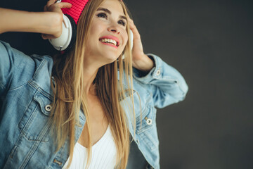Woman with headphones. A young girl listens to music. High quality photo