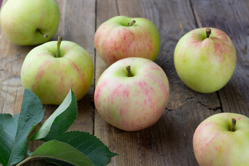 Ripe garden apples on wooden background. Selective focus