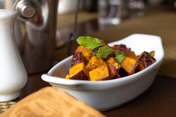 Peruvian food, Sweet Potato in pieces sautéed in oil. Tourist Restaurant of Peru. Latin, South American food. with sweet potato, potato and salad.