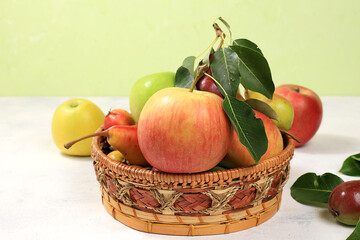Autumn composition of apples and pears on a sunny table, thanksgiving background, harvesting, healthy natural food concept, detox diet and body cleansing, banner for screen, cafe, restaurant