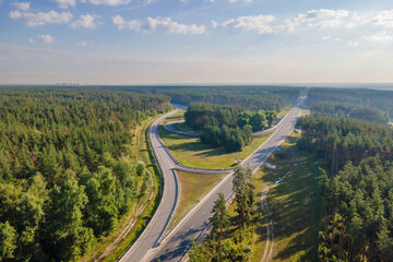 Car traffic transportation on road at junction intersection in countryside forest, aerial view