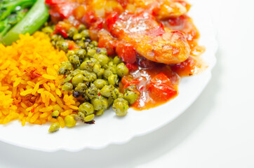 Chicken breast in a tomato and red pepper sauce with spiced long grain rice and crushed minted peas