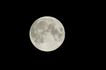 Naklejka na ściany i meble A full moon in a dark black sky over Camp Verde, Yavapai County, Arizona.