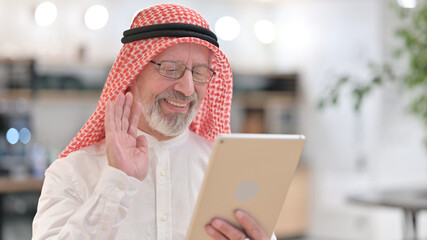 Portrait of Senior Old Arab Businessman Doing Video Chat on Digital Tablet 
