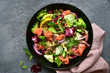 Fresh vegetable salad with salted salmon. Top view with copy space.