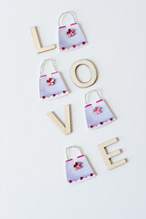 fancy paper hand bags with a dainty flowers and rubies, and the word 