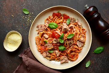 Italian pasta spaghetti with tuna in tomato sauce. Top view with copy space.