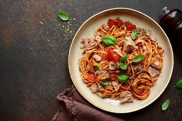 Italian pasta spaghetti with tuna in tomato sauce. Top view with copy space.