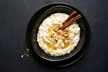 Oat porridge with nuts and maple syrup for a breakfast. Top view with copy space.