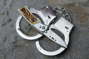 the knife is handcuffed. crime concept