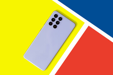 Cell phone concept. mobile phone isolated on a yellow background. colorful background. Top back view. advertising concept