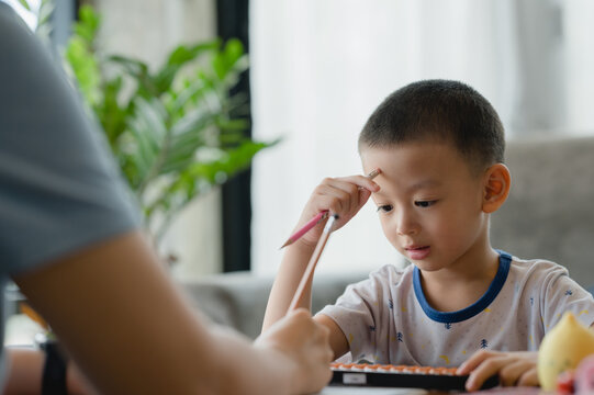 Asian child boy Learning math with an abacus, education concept, home school, Social distancing, stay home, online learning class study math.