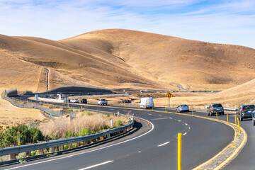 Busy traffic on the winding roads going through the golden hills of Contra Costa County, East San Francisco Bay Area, California