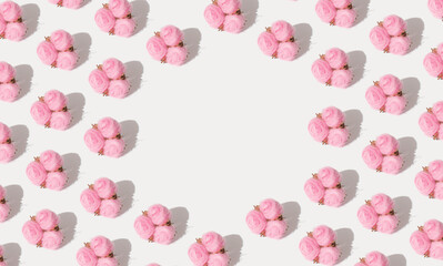Creative pattern made of pink cotton flowers with sunlight shadows. Minimal copy space concept.