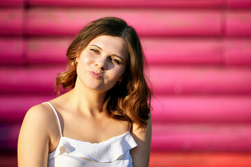 Fototapeta premium European happy woman sits outdoors near building.