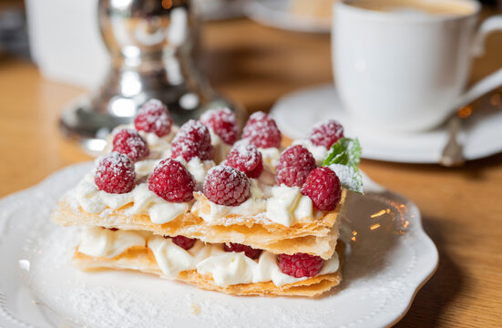 French slavdlka pastries milfey cake with cream and shortcakes and raspberries in a restaurant