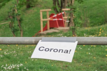 Corona virus quarantine lockdown prohibit playground slide. Closure by barrier tape. Covid-19...