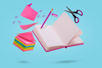 Creative coposition with sicky notes, notebook, pencil, eraser and scissors floating in the air.