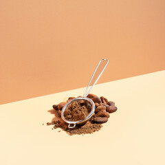 Creative isometric diagonal projection composition with healthy ingredient organic cocoa products: beans, powder on a ivory background. Concept healthcare, energy superfood, brain food. Copy space