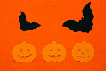 Felt bats and pumpkins on a felt background