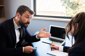 Young businessman explaining his new idea to female partner, making plans and working together.