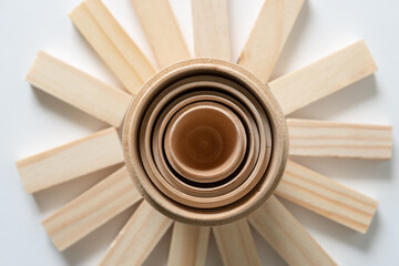 wooden objects (rings) with radiating wooden tiles below 