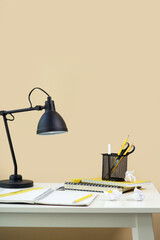 Education and back to school concept: table lamp, notebooks and school stationery on the table.	