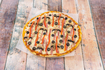 Whimsical Italian Pizza Recipe with Ham, Black Olives, Red Peppers, Mushrooms, and Oregano