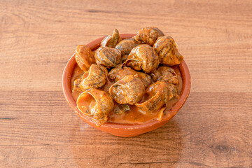 Bowl of snails. Typical Spanish snail stew with spicy sauce served in a tapas restaurant.