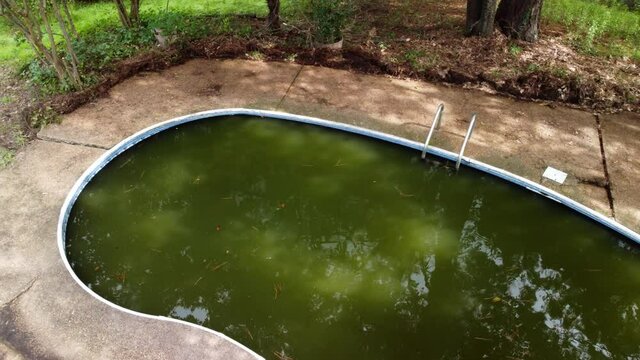 Abandoned swimming pool in disrepair